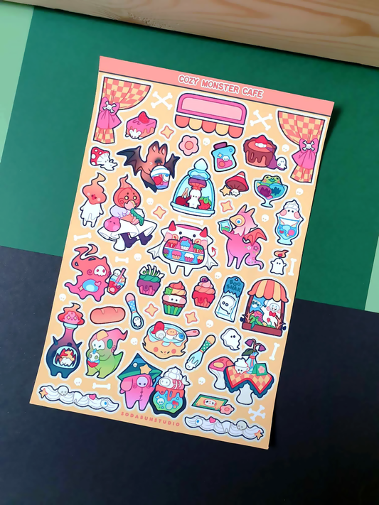 Coy Apricot Cozy Monster Cafe Sticker Sheet featuring cute monsters with cafe treats like coffee, pastries, and more, in bright vibrant colours for journaling and scrapbooking. Front view.